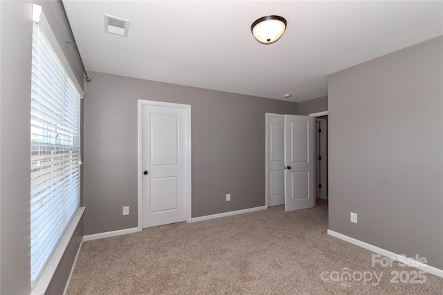 unfurnished bedroom with light carpet