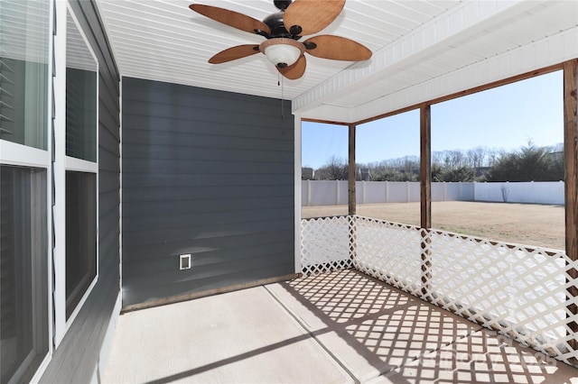 unfurnished sunroom with ceiling fan