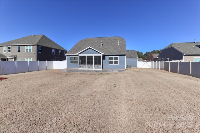 rear view of property with a sunroom