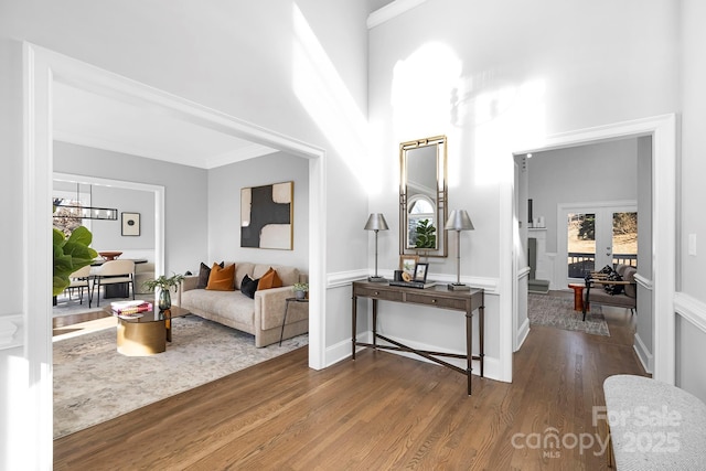 interior space featuring hardwood / wood-style floors, crown molding, and french doors