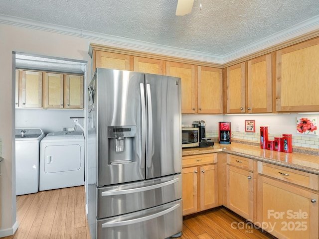 kitchen with light stone countertops, independent washer and dryer, light brown cabinetry, appliances with stainless steel finishes, and ornamental molding