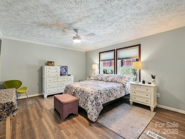 bedroom featuring a textured ceiling, dark hardwood / wood-style floors, ceiling fan, and ornamental molding