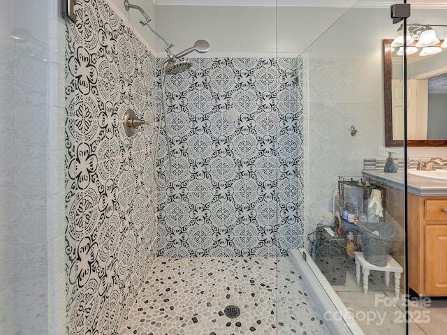 bathroom with tiled shower, vanity, and tile patterned floors