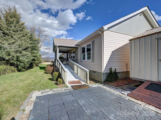 view of home's exterior with a yard and a patio