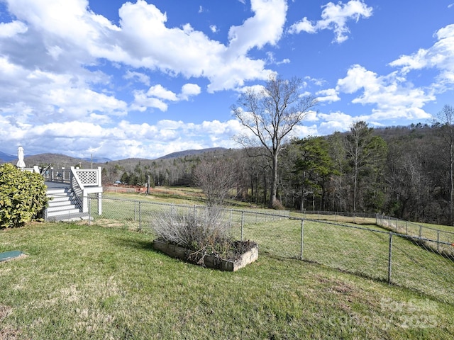 view of yard with a mountain view and a rural view