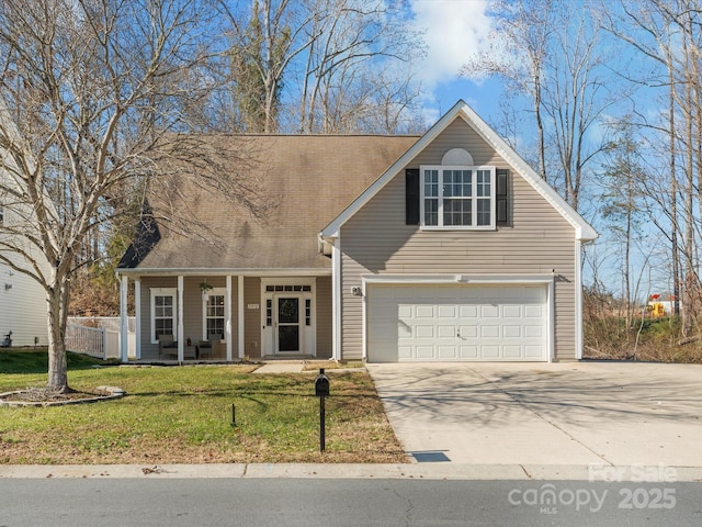 view of front of property featuring a porch, a front yard, and a garage