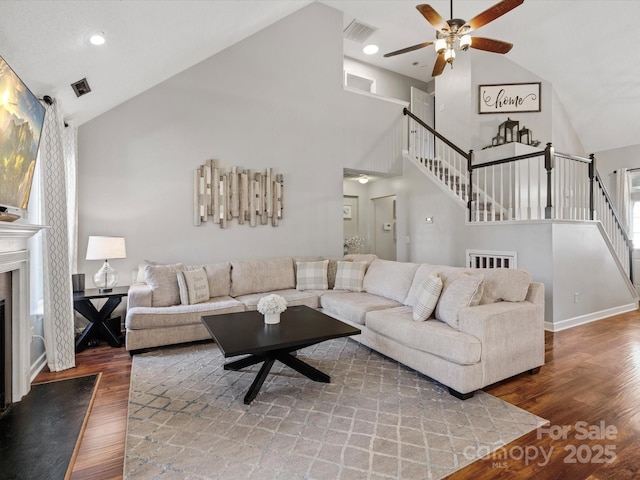 living room featuring wood-type flooring, high vaulted ceiling, and ceiling fan