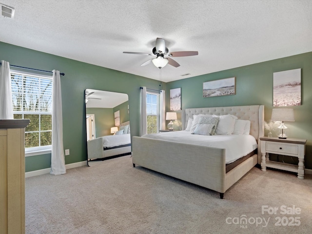 carpeted bedroom with a textured ceiling and ceiling fan