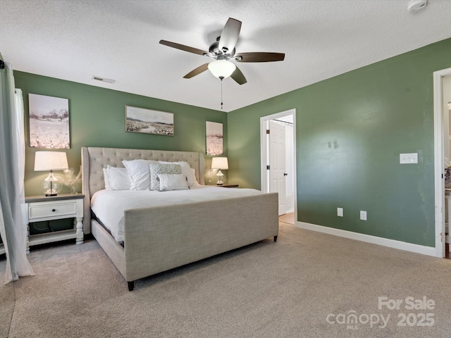 carpeted bedroom featuring a textured ceiling and ceiling fan