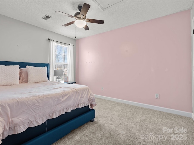 bedroom featuring ceiling fan, carpet, and a textured ceiling