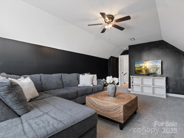 living room featuring a textured ceiling, ceiling fan, vaulted ceiling, and carpet floors