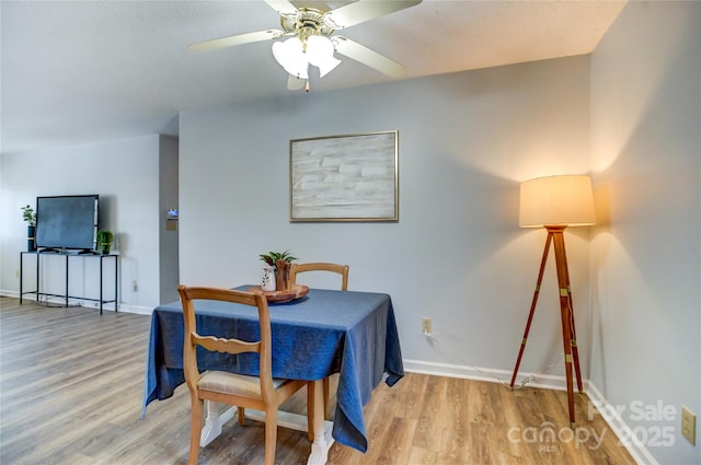 dining space featuring ceiling fan and light hardwood / wood-style floors