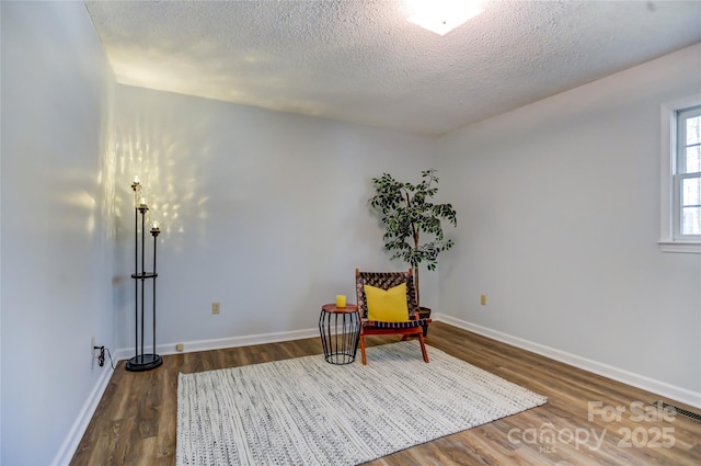 unfurnished room featuring dark hardwood / wood-style floors and a textured ceiling