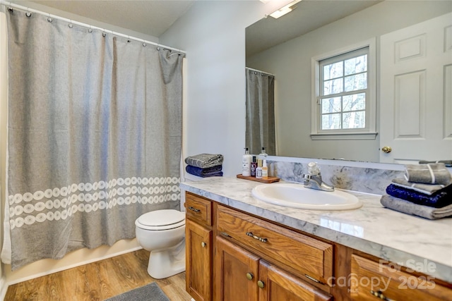 bathroom with hardwood / wood-style floors, vanity, and toilet