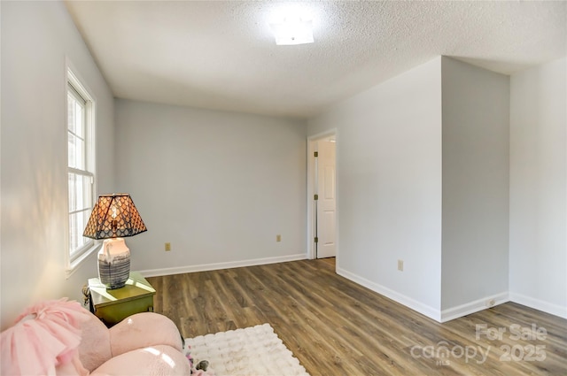 unfurnished room featuring a textured ceiling and hardwood / wood-style flooring