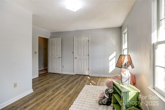 rec room with a textured ceiling and hardwood / wood-style flooring