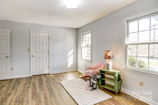 interior space with a textured ceiling and hardwood / wood-style flooring