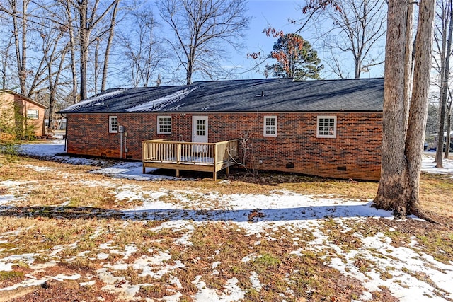 snow covered property with a deck