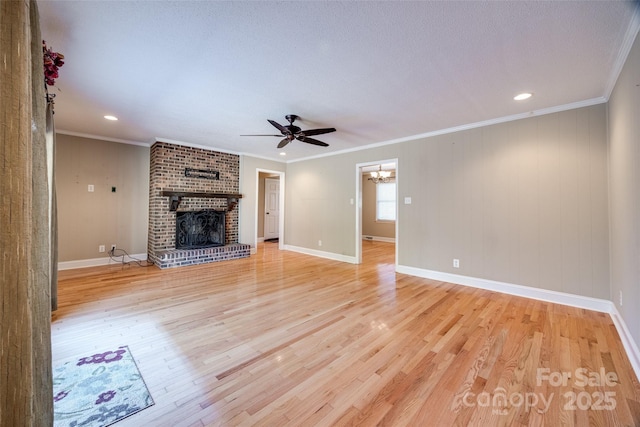 unfurnished living room with a fireplace, light hardwood / wood-style floors, and crown molding