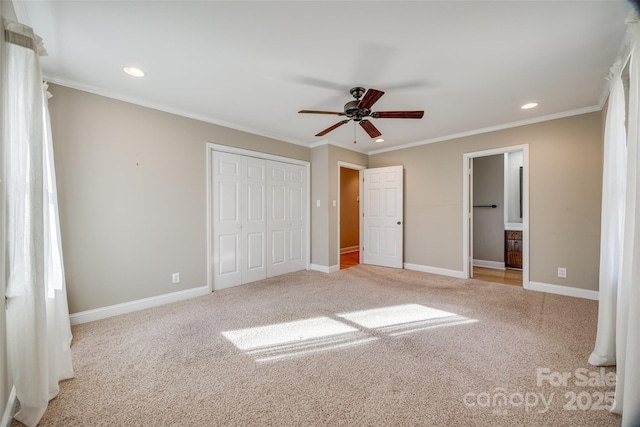 unfurnished bedroom featuring light colored carpet, ceiling fan, crown molding, and ensuite bathroom