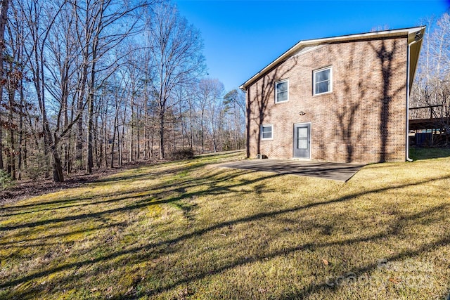 back of house featuring a yard and a patio