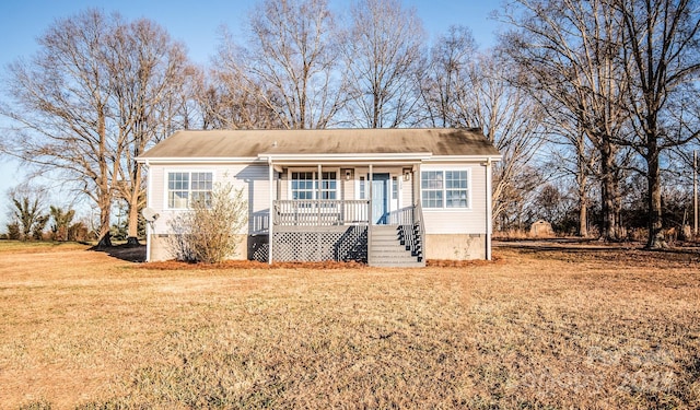 view of front of home with a porch and a front yard