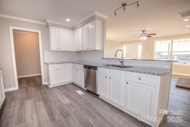 kitchen with dishwasher, light hardwood / wood-style flooring, white cabinetry, and sink