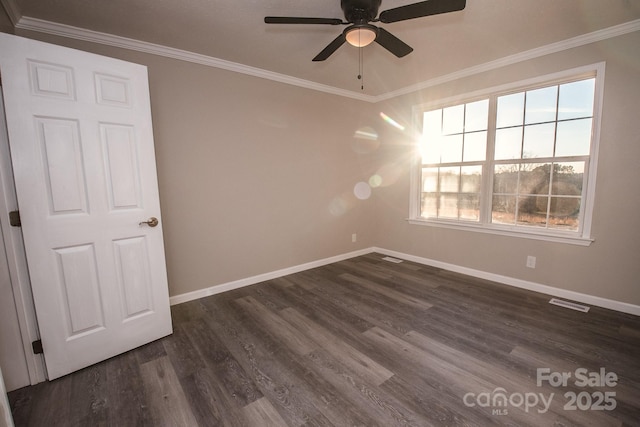 empty room with dark hardwood / wood-style floors, ceiling fan, and crown molding