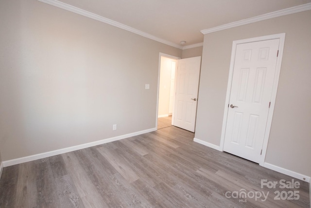 unfurnished bedroom with crown molding and light hardwood / wood-style flooring