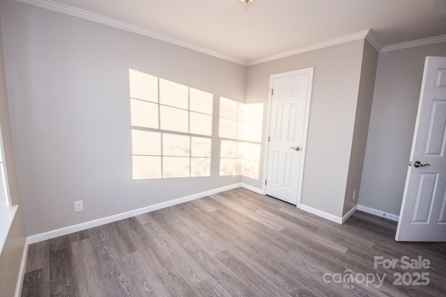 unfurnished room featuring crown molding and hardwood / wood-style flooring