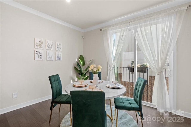 dining area with ornamental molding, wood finished floors, and baseboards