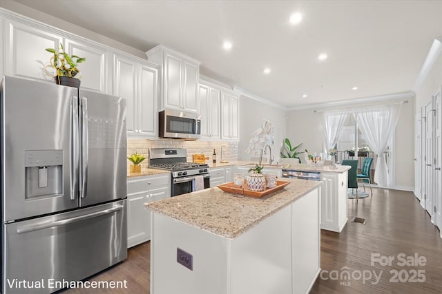 kitchen featuring a peninsula, white cabinetry, and stainless steel appliances