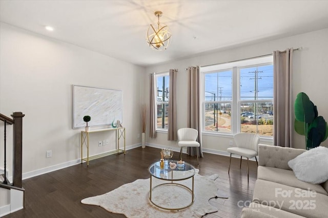 living area featuring a notable chandelier, recessed lighting, wood finished floors, baseboards, and stairs