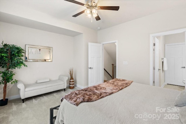 bedroom with a ceiling fan, light colored carpet, and baseboards