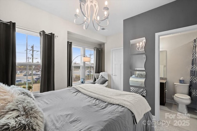 bedroom featuring baseboards and an inviting chandelier