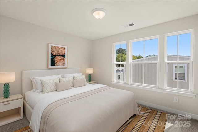 bedroom featuring baseboards and visible vents