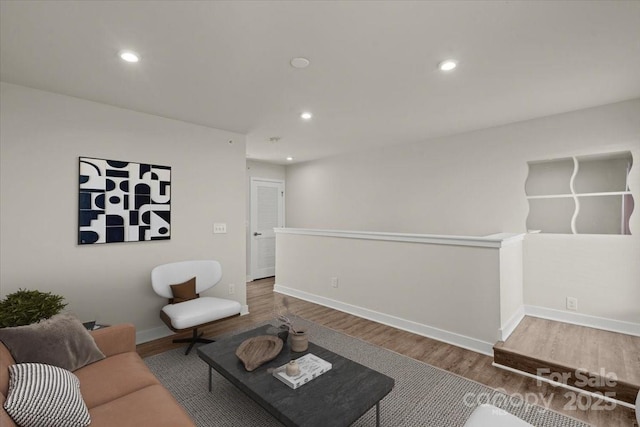 living room with recessed lighting, baseboards, and wood finished floors