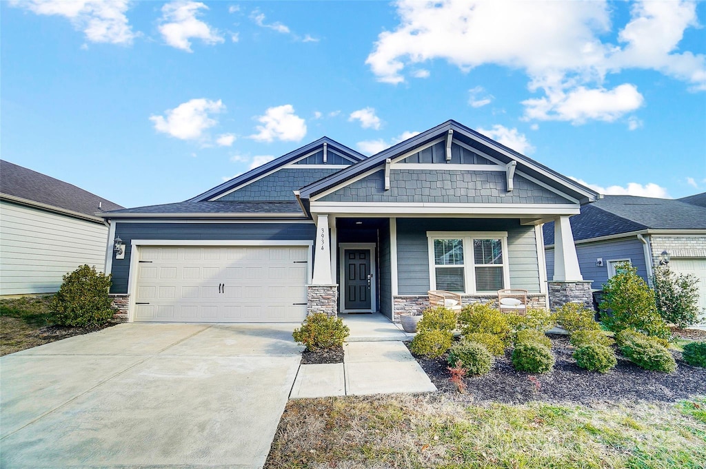 craftsman-style home with covered porch and a garage