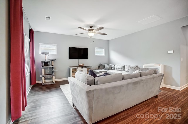 living room featuring dark hardwood / wood-style floors and ceiling fan