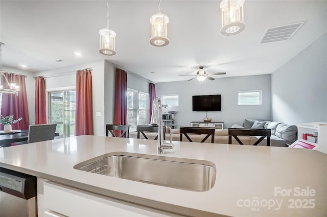 kitchen with pendant lighting, dishwasher, plenty of natural light, and sink