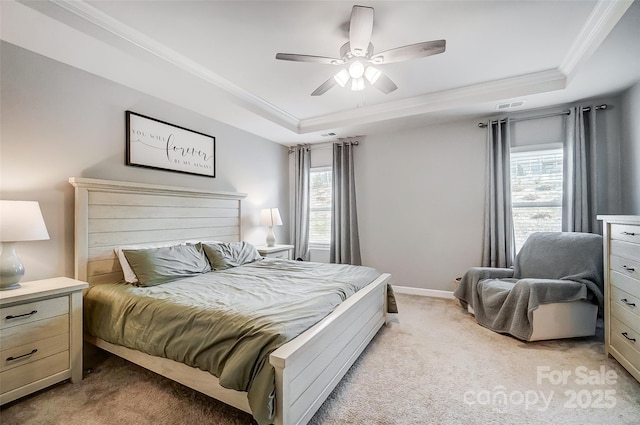 carpeted bedroom featuring multiple windows, a tray ceiling, ceiling fan, and crown molding