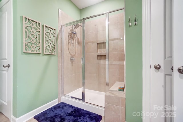 bathroom featuring a shower with shower door