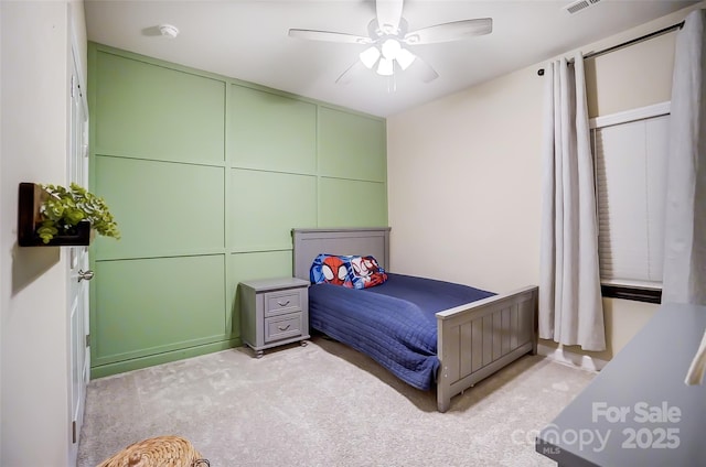 bedroom featuring ceiling fan and light carpet