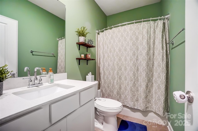 bathroom featuring vanity, toilet, and curtained shower