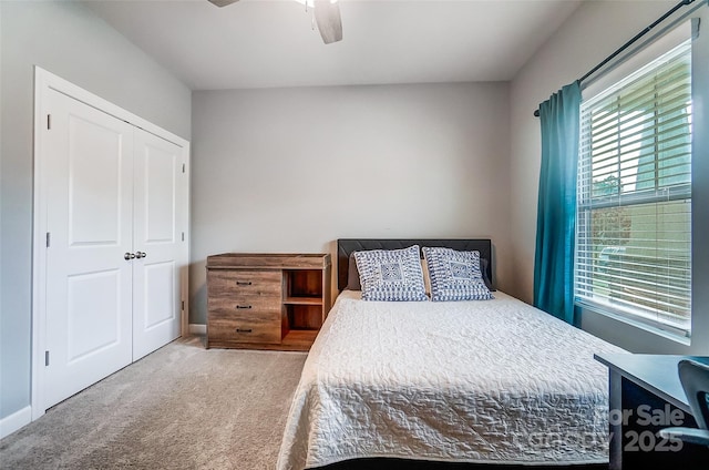 carpeted bedroom featuring a closet and ceiling fan