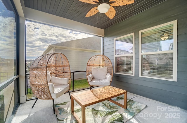 sunroom featuring ceiling fan