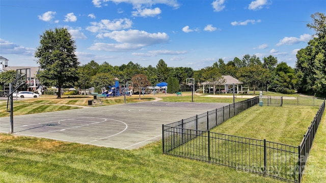 view of basketball court with a playground and a yard