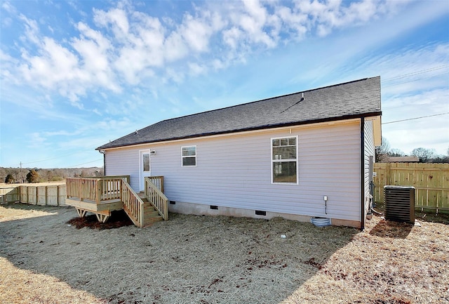 rear view of house with a wooden deck and central AC