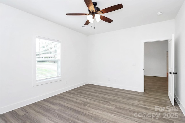 2365 28th St NE, Hickory, NC 28601 - unfurnished room with baseboards, ceiling fan, and wood finished floors