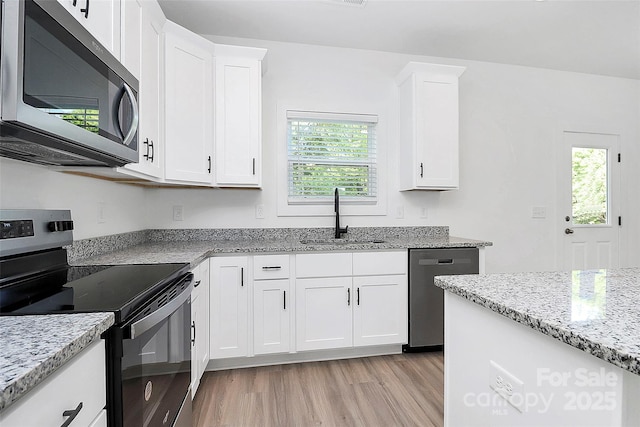 2365 28th St NE, Hickory, NC 28601 - kitchen with plenty of natural light, stainless steel appliances, light wood-style flooring, and a sink